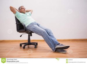 leaning back in chair mature man leaning back swivel chair home living room